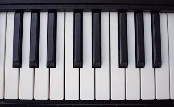 Close-up of piano keys. Piano black and white keys and Piano keyboard musical instrument placed at the home balcony during sunny day. photo