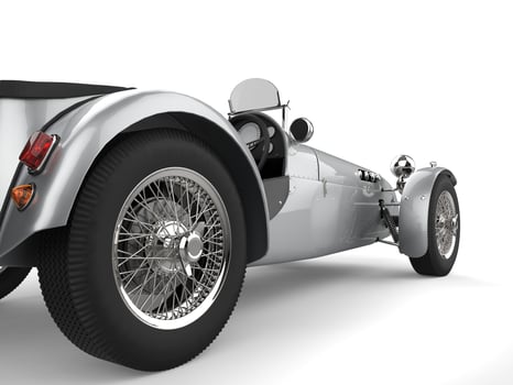 Vintage metallic silver open wheel sport racing car - rear wheel closeup shot photo