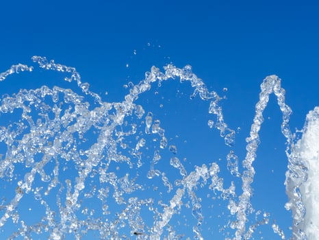 Fresh water streams shooting up from the fountain photo