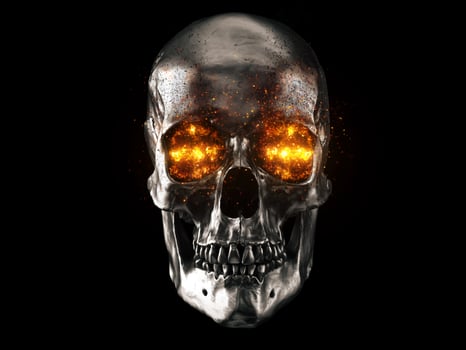 Metallic skull with red hot burning eyes photo