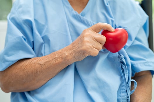 Doctor holding a red heart in hospital, healthy strong medical concept. photo