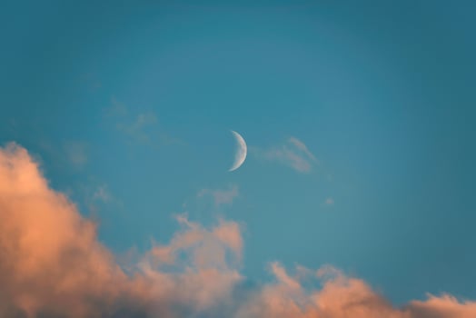 Crescent moon glowing and evening cloud on blue sky photo