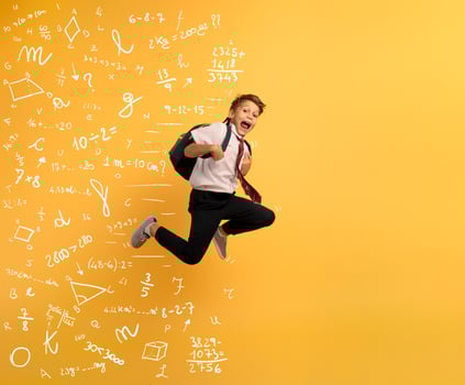 Young boy student runs fast to escape from school. Yellow background photo