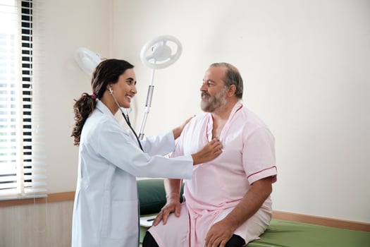 Female doctors in uniform healthy check White male patients in examination coat by stethoscope, and checkups and advise health care diagnosis at clinic hospital, and appointments visit. photo
