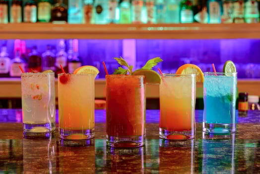 various Cocktail Collection with varying glassware, Handmade Craft Cocktails, dalcoholic beverages. On the bar, in the restaurant, behind it is a liquor showcase. photo