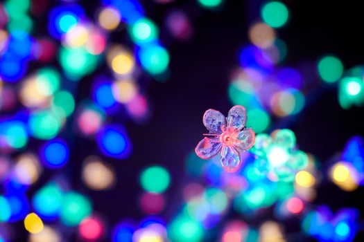 Colorful lights bokeh from decorative luminous flowers garlands at holiday, multicolored lights photo