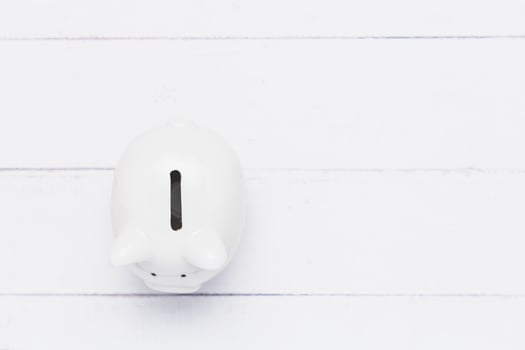 Saving piggy bank on white table background for investment, business, finance and saving money concept photo