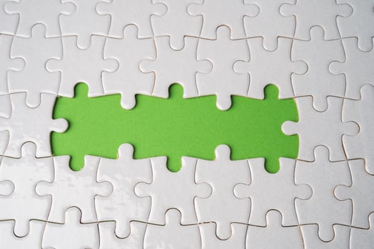 Jigsaw puzzle on green background, business teamwork, problem solving concept. photo