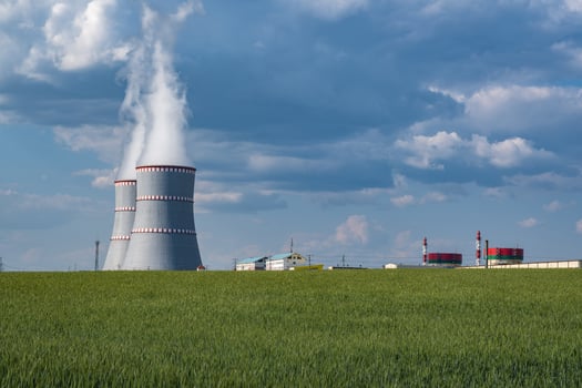 Cooling towers of nuclear power plant against the blue sky photo