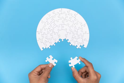 Two hands of businessman to connect couple puzzle piece. symbol of association and connection. business strategy. photo