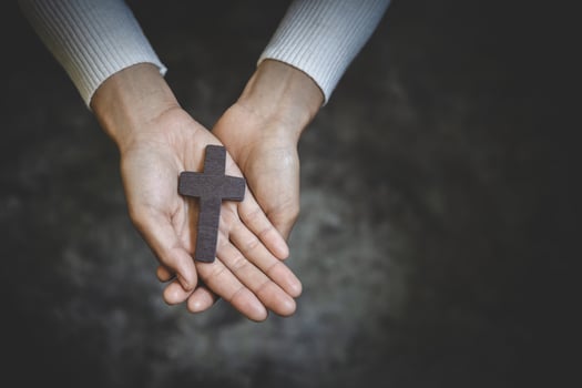 Human hand holds cross, Worship, sins and prayer, Religious concept. Eucharist Therapy Bless God Helping Repent Catholic Easter Lent Mind Pray. photo