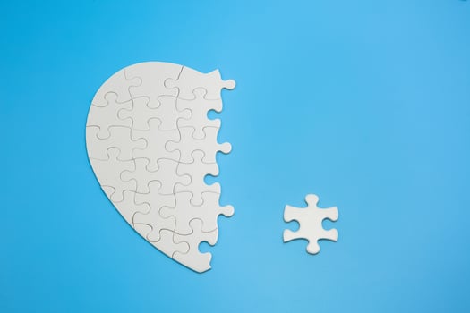 Unfinished white jigsaw puzzle pieces on blue background,  Copy space. photo