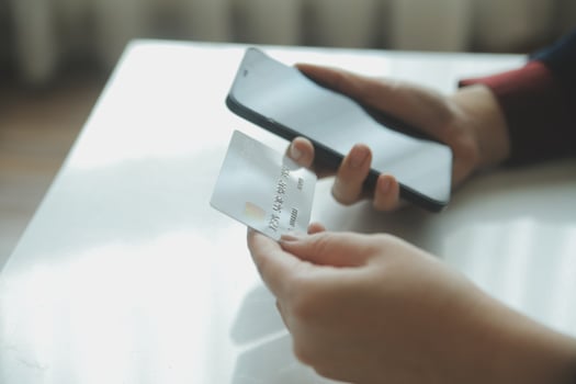 Woman hands holding and using cradit card for shopping online. photo