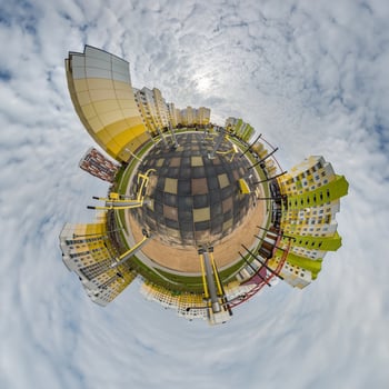 tiny planet in blue sky with clouds in city center near modern skyscrapers in residential complex. Transformation of spherical 360 panorama in abstract aerial view. photo