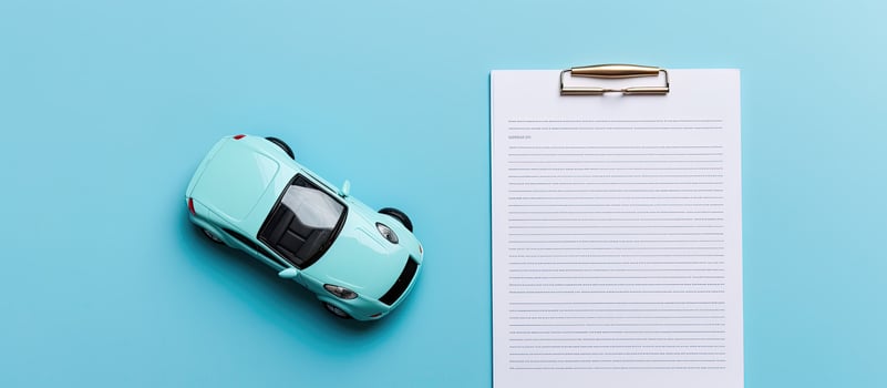 A blue toy car next to a paper with a pen on it created with technology photo