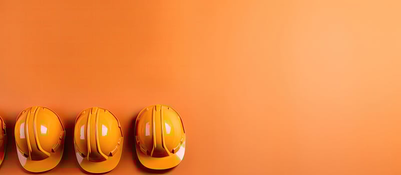A row of yellow hard hats hanging on a wall created with technology photo