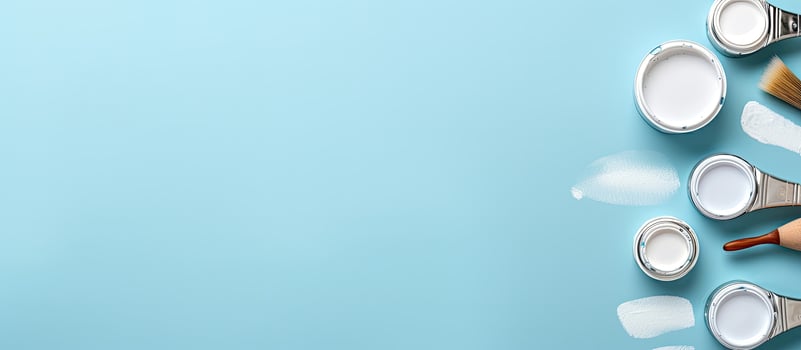 A group of paint cans and a brush on a blue background created with technology photo