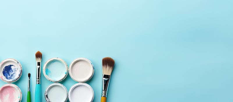 A group of paint brushes sitting on top of a blue surface created with technology photo