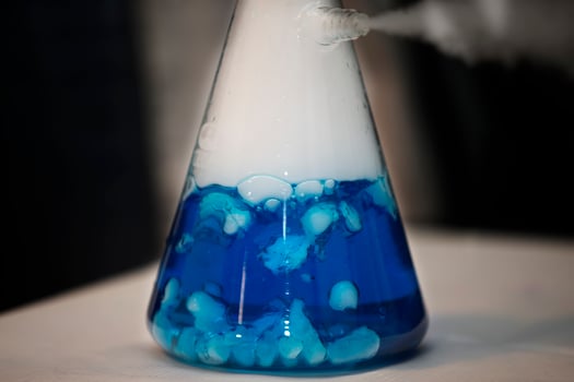 Chemical flask with blue solution. Experiences and experiments. photo