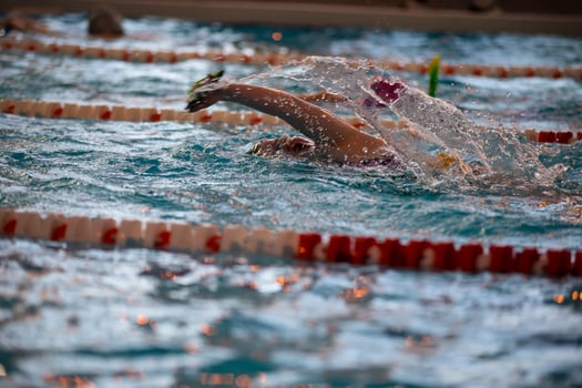 Child athlete swims in the pool. Swimming section. photo