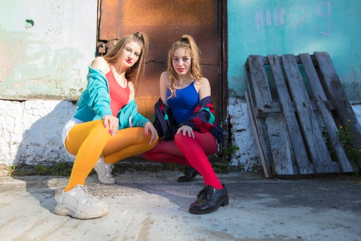 Funny girls in the style of the 90s in bright clothes. photo