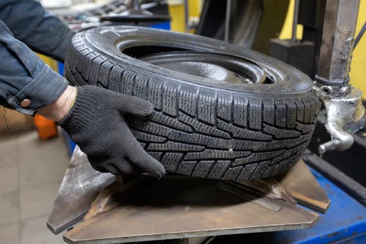 Tire service. The mechanic's hands hold the wheel of the car. Wheel repair. photo