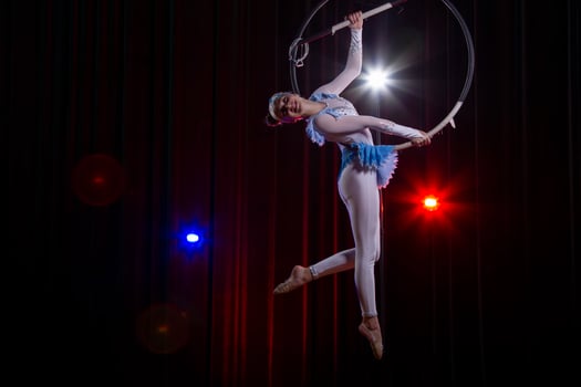 Circus acrobats gymnasts perform on a stage dark background. photo