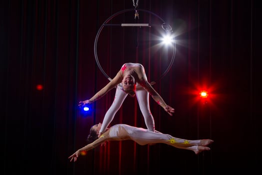 Circus acrobats gymnasts perform on a stage dark background. photo