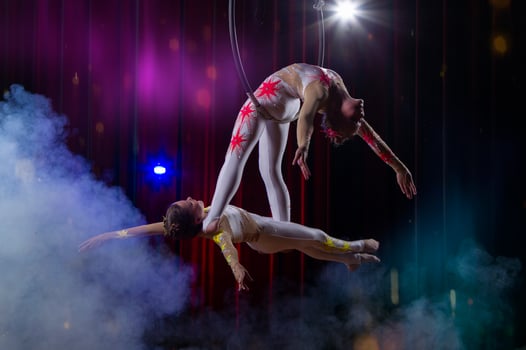Circus acrobats gymnasts perform on a stage dark background. photo