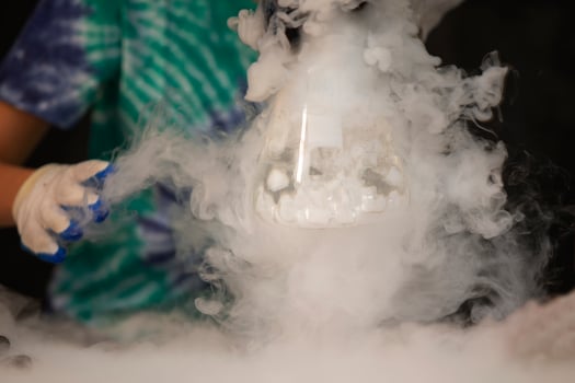 Glass flask with puffs of smoke as a result of liquid nitrogen reaction. photo