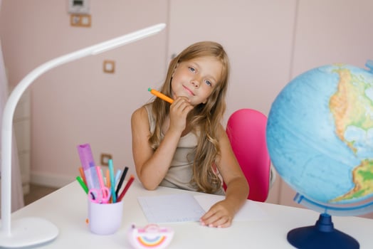 Young girl doing homework. Schoolgirl at home learning photo