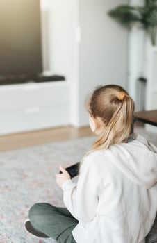 Girl playing video game at home photo