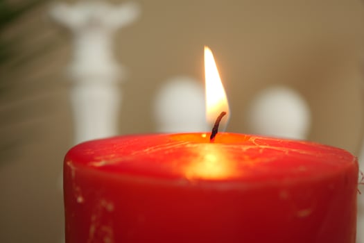 color candles slowly burning down in dark photo