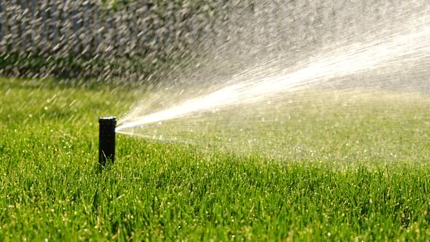 Automatic garden irrigation system watering lawn with adjustable head. Automatic equipment for irrigation and maintenance of lawns, gardening. photo