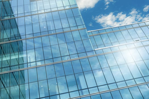 Modern sustainable glass office building. Exterior view of corporate headquarters glass building architecture. Energy-efficient building. Financial business center tower. Glass windows of company. photo