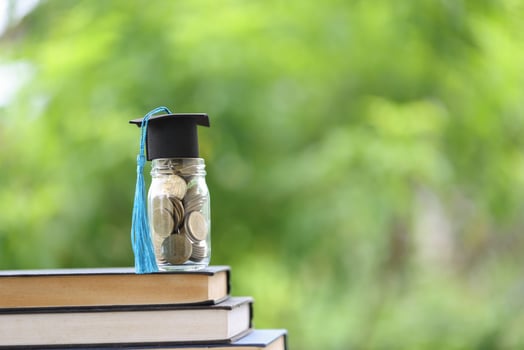 Knowledge and Success Graduation Cap on Books Against a Beautiful Nature Background. Achievement Unlocked Graduation Cap and Books Symbolize Education Savings and Academic Growth. photo