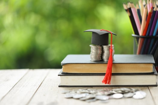 Knowledge and Success Graduation Cap on Books Against a Beautiful Nature Background. Achievement Unlocked Graduation Cap and Books Symbolize Education Savings and Academic Growth. photo