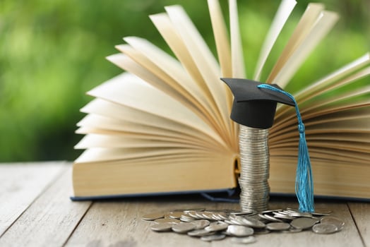 Knowledge and Success Graduation Cap on Books Against a Beautiful Nature Background. Achievement nlocked Graduation Cap and Books Symbolize Education Savings and Academic Growth. photo