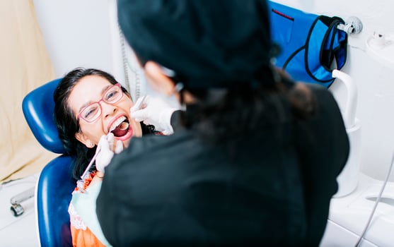 Top view of dentist doing dental checkup, patient checked by dentist, close up of dentist with patient, dentist doing root canal treatment on patient photo