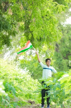 Indian boy holding national flag in farm, happy boy, national flag photo