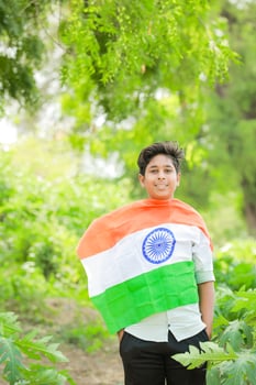 Indian boy holding national flag in farm, happy boy, national flag photo