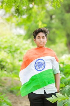 Indian boy holding national flag in farm, happy boy, national flag photo