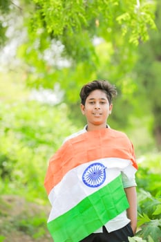 Indian boy holding national flag in farm, happy boy, national flag photo