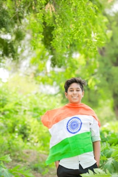 Indian boy holding national flag in farm, happy boy, national flag photo