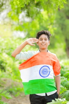 Indian boy holding national flag in farm, happy boy, national flag photo
