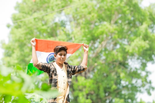 Indian boy holding national flag in farm, happy boy, national flag photo