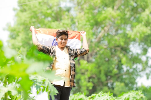 Indian boy holding national flag in farm, happy boy, national flag photo