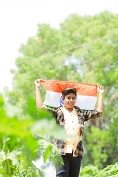 Indian boy holding national flag in farm, happy boy, national flag photo