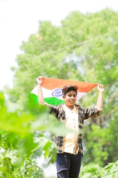 Indian boy holding national flag in farm, happy boy, national flag photo