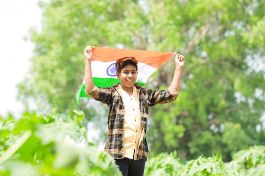 Indian boy holding national flag in farm, happy boy, national flag photo